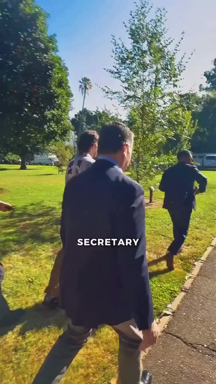 Xavier Becerra walking away from reporters